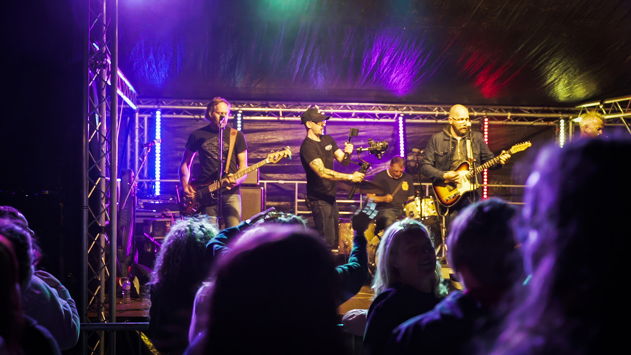 Innov8 Digital Media LTD Founder, Adam Milton-Barker on stage filming a band at Dysfest in North Wales